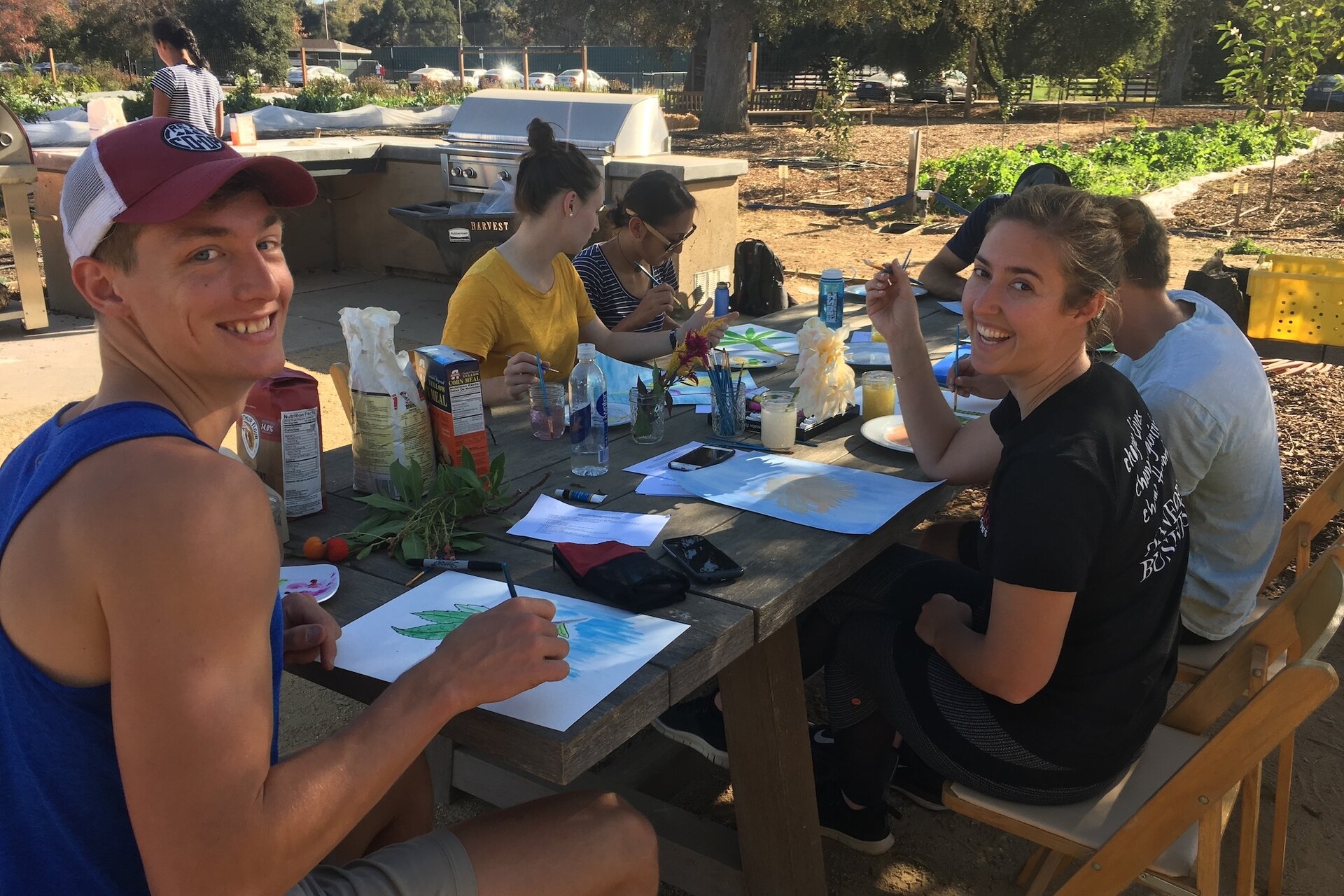 A group of people outdoors at a table