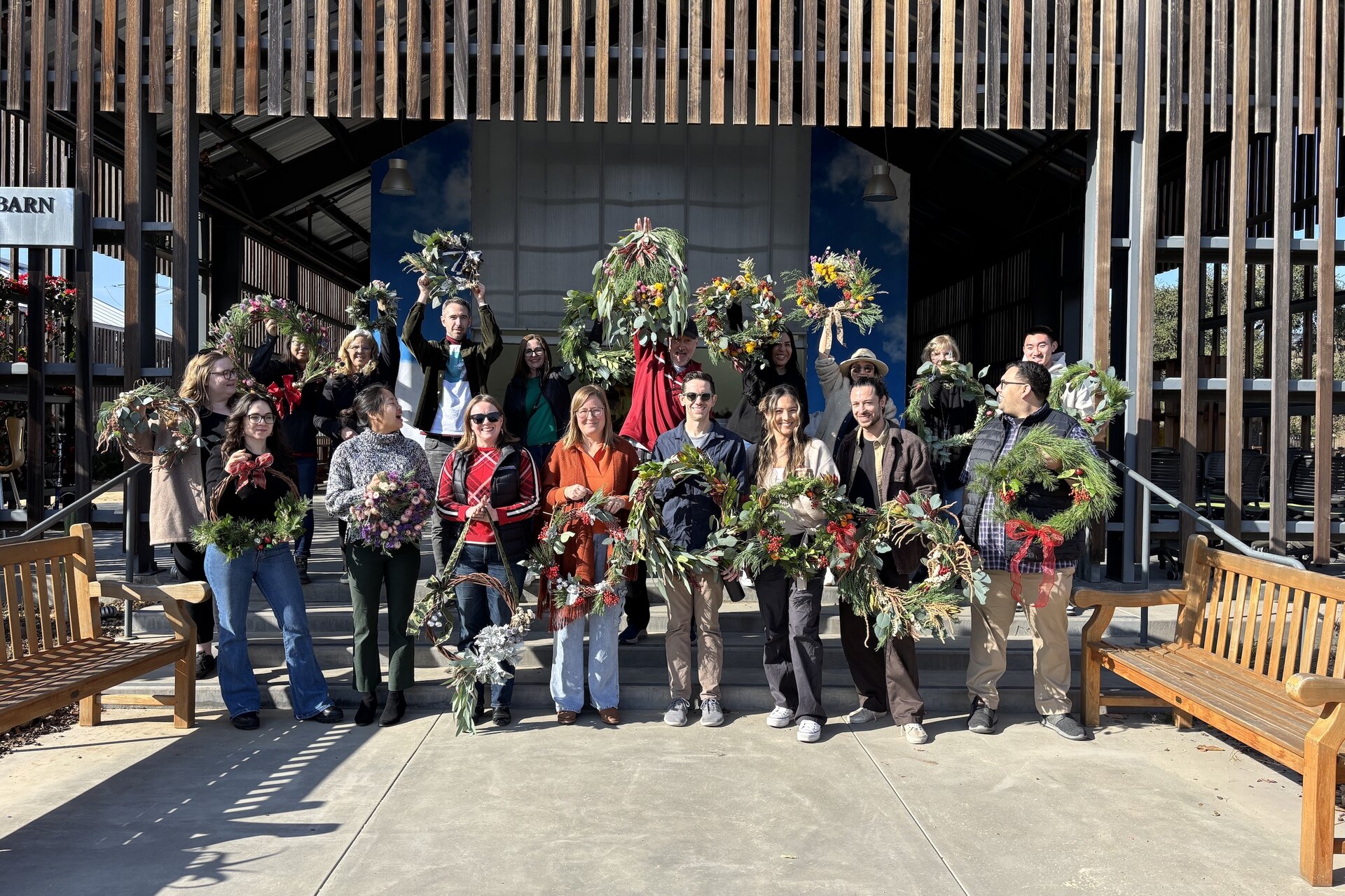 A group shot of people outside the barn