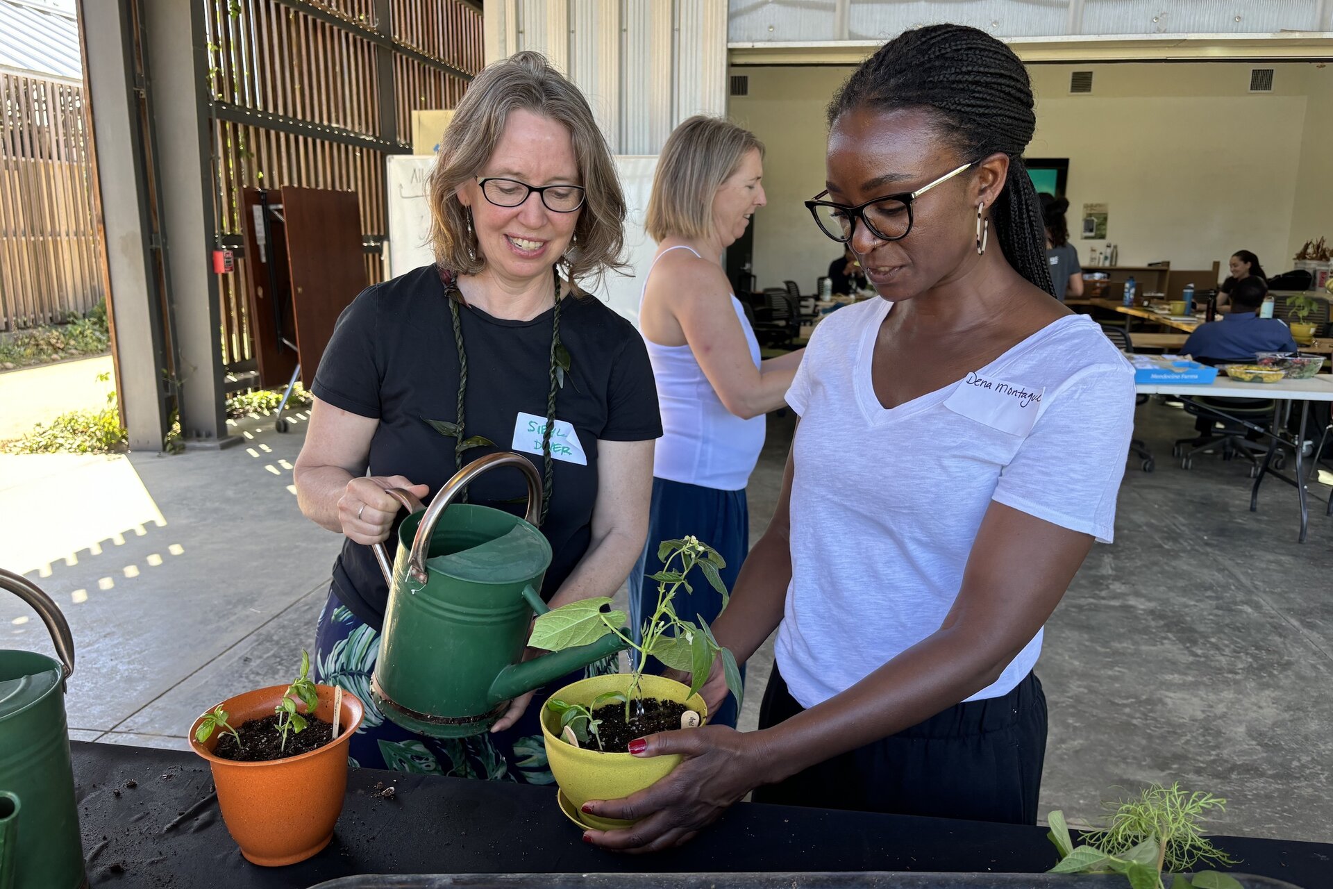 Two people with plants